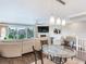 Bright living room with glass dining table, comfortable seating and water views at 521 Pinellas Bayway S # 107, St Petersburg, FL 33715