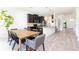 Bright dining room with wood table and gray chairs, overlooking backyard at 5308 105Th E Ter, Parrish, FL 34219