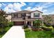 Two-story house with brown roof, tan and white siding, and a two-car garage at 5308 105Th E Ter, Parrish, FL 34219