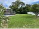 Large backyard with a screened pool and plenty of grass at 5404 Glover Dr, Weeki Wachee, FL 34607