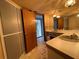 Bathroom with double vanity, tiled floor, and access to exterior at 5404 Glover Dr, Weeki Wachee, FL 34607