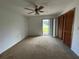 Spacious bedroom with carpet flooring and sliding glass door leading to backyard at 5404 Glover Dr, Weeki Wachee, FL 34607