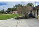 Attached garage with large driveway and pink crape myrtle at 5404 Glover Dr, Weeki Wachee, FL 34607