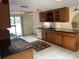 Kitchen with wood cabinets, granite counters and tile floor at 5404 Glover Dr, Weeki Wachee, FL 34607