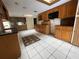 Kitchen boasts wood cabinets, granite counters, and tile floors at 5404 Glover Dr, Weeki Wachee, FL 34607