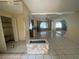 Spacious living room with tile floors, stone fireplace, and pool view at 5404 Glover Dr, Weeki Wachee, FL 34607