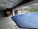 Large swimming pool with a protective cover and a screened enclosure at 5404 Glover Dr, Weeki Wachee, FL 34607