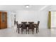 Bright dining room with tile floors and a wooden table with four chairs at 5618 Chipper Dr, New Port Richey, FL 34652