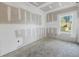 Image of an unfinished bedroom with a window at 5725 Desert Rose Pl, Tampa, FL 33615