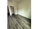 This bedroom features wood-look flooring and a closet space, offering a comfortable and functional living area at 5725 Desert Rose Pl, Tampa, FL 33615