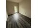 A bright, serene room featuring wood-look floors and access to the outdoors, ready for your personal touch at 5725 Desert Rose Pl, Tampa, FL 33615