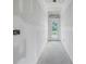 Unfinished interior hallway; white walls, concrete floor at 5725 Desert Rose Pl, Tampa, FL 33615