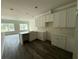 Open kitchen featuring new white cabinets, light countertops, and ample natural light from the nearby windows at 5725 Desert Rose Pl, Tampa, FL 33615