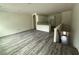 A spacious living area with new dark laminate flooring leads to a staircase and an open kitchen at 5725 Desert Rose Pl, Tampa, FL 33615