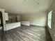 Bright living room with new wood-look flooring, leading to the kitchen, and featuring lots of natural light at 5725 Desert Rose Pl, Tampa, FL 33615