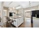 Kitchen with island, white cabinets and appliances at 7060 40Th N Ter, St Petersburg, FL 33709