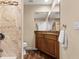 Bathroom featuring wood cabinets, granite countertop, and a tiled shower at 709 Mandalay Ave, Clearwater Beach, FL 33767