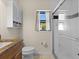 Bathroom features a glass shower, tiled floor, and white cabinets with a granite vanity at 709 Mandalay Ave, Clearwater Beach, FL 33767