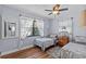 Comfortable bedroom with two twin beds, wood floors, and a ceiling fan at 709 Mandalay Ave, Clearwater Beach, FL 33767
