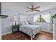 Cozy bedroom offers wood floors, a queen bed, and two bedside tables with lamps at 709 Mandalay Ave, Clearwater Beach, FL 33767