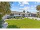 Charming single-story home with beautiful landscaping and a well-manicured lawn at 709 Mandalay Ave, Clearwater Beach, FL 33767