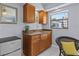 A close-up view of a kitchenette that features granite counters and wooden cabinets at 709 Mandalay Ave, Clearwater Beach, FL 33767