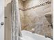 Shower featuring textured tiling, white trim, and a patterned shower curtain at 709 Mandalay Ave, Clearwater Beach, FL 33767