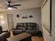 Living room with leather couches and a ceiling fan at 802 W Sligh Ave, Tampa, FL 33604