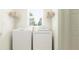 Bright laundry room with washer, dryer, and shelving at 8411 Bella Mar Trl, Parrish, FL 34219