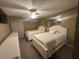 Two twin beds in a bright bedroom with a ceiling fan and mirror at 855 Bayway Blvd # 902, Clearwater Beach, FL 33767