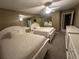 Two twin beds in a well-lit bedroom with a ceiling fan at 855 Bayway Blvd # 902, Clearwater Beach, FL 33767