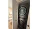 Compact laundry room with stacked LG washer/dryer at 855 Bayway Blvd # 902, Clearwater Beach, FL 33767