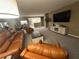 Spacious living room with leather sofas and a large TV at 855 Bayway Blvd # 902, Clearwater Beach, FL 33767
