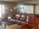 Living room with leather furniture and large mirror at 855 Bayway Blvd # 902, Clearwater Beach, FL 33767