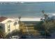 Beach and walkway with palm trees and calm water at 855 Bayway Blvd # 902, Clearwater Beach, FL 33767
