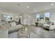 Bright living room with L-shaped sectional and hardwood floors at 8721 Sap Creek Pl, Tampa, FL 33614