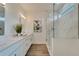 Elegant bathroom featuring a walk-in shower and marble tile at 8791 Sap Creek Pl, Tampa, FL 33614