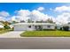 White single story home with attached garage and well manicured lawn at 9047 143Rd St, Seminole, FL 33776