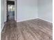 Simple bedroom with wood-look floors and access to another room at 1001 77Th N Ave # 104, St Petersburg, FL 33702