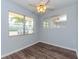 Light blue bedroom with wood-look floors and ceiling fan at 1001 77Th N Ave # 104, St Petersburg, FL 33702