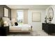 Serene bedroom with a bed, dresser, and an accent wall at 10269 Purple Leaf Ct, Riverview, FL 33578
