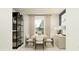 Modern dining room with glass-front cabinet and wood dining table at 10269 Purple Leaf Ct, Riverview, FL 33578