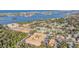 Expansive aerial scene of a condo complex near water, surrounded by tropical trees and houses at 12760 Indian Rocks Rd # 582, Largo, FL 33774