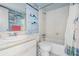 Bathroom featuring a vanity, toilet, and shower/tub combination with nautical themed wallpaper at 12760 Indian Rocks Rd # 582, Largo, FL 33774