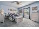 Airy bedroom with blue walls, white wicker furniture, and ample natural light at 12760 Indian Rocks Rd # 582, Largo, FL 33774