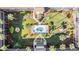 Overhead view of condo complex courtyard oasis with pool, lounge chairs, and manicured landscaping at 12760 Indian Rocks Rd # 582, Largo, FL 33774