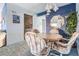 Dining area featuring a round table, four chairs, and adjacent kitchen view at 12760 Indian Rocks Rd # 582, Largo, FL 33774