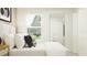 Bedroom with a queen bed, window, and built-in closet at 13024 Calcite Blue Ave, Wimauma, FL 33598