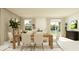 Bright dining room with wooden table and access to backyard at 13024 Calcite Blue Ave, Wimauma, FL 33598