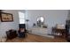 Bedroom featuring hardwood floors, ample lighting, and a comfortable seating area at 13621 Mcintosh Rd, Thonotosassa, FL 33592